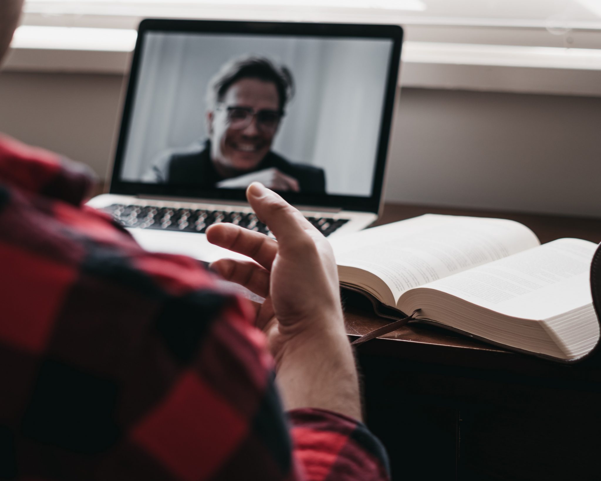 two men chatting over video call